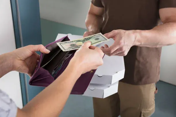 Female delivery person accepts next ride. stock photo