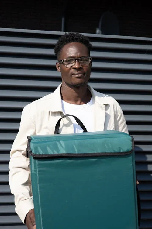Courier holding an insulated delivery bag ready for a drop-off