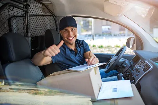 Delivery Man Gives Postal Package to a Business Customer, Who Signs Electronic Signature POD Device. In Stylish Modern Urban Office Area Courier Delivers Cardboard Box Parcel to a Man delivery driver stock pictures, royalty-free photos & images
