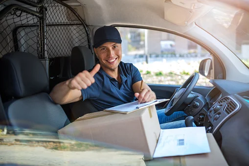 Delivery Man Gives Postal Package to a Business Customer, Who Signs Electronic Signature POD Device. In Stylish Modern Urban Office Area Courier Delivers Cardboard Box Parcel to a Man delivery driver stock pictures, royalty-free photos & images