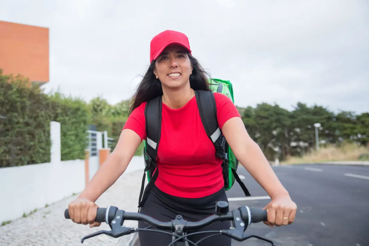 Bike delivery rider smiling before a shift, one of the part time delivery options that needs no driving licence