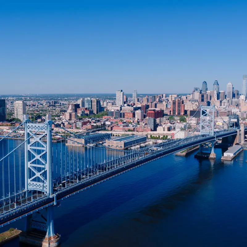 Aerial view of the Benjamin Franklin Bridge crossing the Delaware River into Philadelphia, with the Center City skyline behind