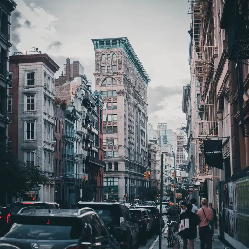 A street of cast-iron buildings in SoHo, Manhattan, with traffic and pedestrians
